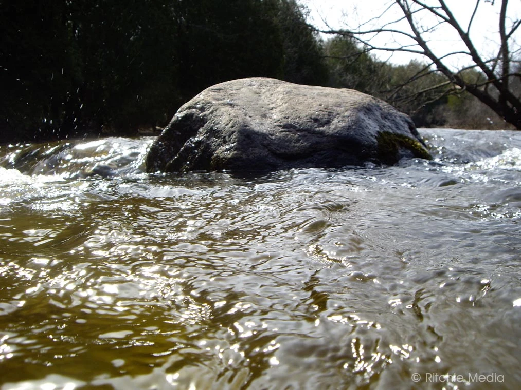 pickture of a large rock in the middle of a flowing creek - Jackson Park, Peterborough ON