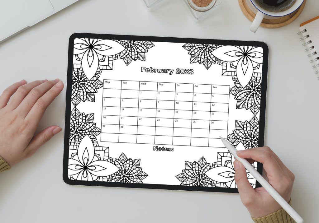 ipad pro in womans hands showing coloring calendar page